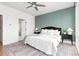 Bright bedroom with a large window, ceiling fan, black nightstands, and soft bedding at 332 Gibson Se St, Atlanta, GA 30316
