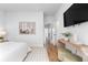 Open bedroom leading to ensuite bath; wood floors, stylish decor, tv at 332 Gibson Se St, Atlanta, GA 30316
