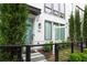 Modern home featuring a white brick facade, black framed windows and door, with manicured landscaping at 332 Gibson Se St, Atlanta, GA 30316