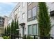 Stylish townhome featuring a white brick exterior, black accents, and well-maintained landscaping at 332 Gibson Se St, Atlanta, GA 30316