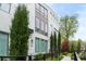 Modern townhome with white brick, black window frames, and manicured landscaping at 332 Gibson Se St, Atlanta, GA 30316