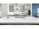 Modern kitchen with stainless steel appliances, gray cabinets, and white countertops at 332 Gibson Se St, Atlanta, GA 30316