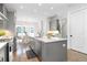 A view of the modern kitchen island with stainless steel appliances, sink and hardwood flooring at 332 Gibson Se St, Atlanta, GA 30316