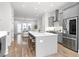 Open concept kitchen with stainless steel appliances, hardwood floors and a large kitchen island at 332 Gibson Se St, Atlanta, GA 30316