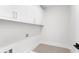 Well-lit laundry room with white cabinetry and tile flooring at 332 Gibson Se St, Atlanta, GA 30316
