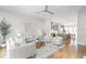 Bright, open-concept living room featuring hardwood floors and modern white furniture at 332 Gibson Se St, Atlanta, GA 30316