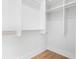 A walk-in closet featuring built-in shelves, wood floor and ample storage at 332 Gibson Se St, Atlanta, GA 30316