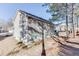 Exterior view of home with a spacious backyard and tree coverage providing shade at 4089 Palm Dr, Snellville, GA 30039