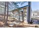 Backyard with mature trees and the back of the house, and a small concrete seating area at 4089 Palm Dr, Snellville, GA 30039