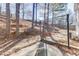 Backyard with mature trees, a seating area, and a bench, perfect for outdoor relaxation at 4089 Palm Dr, Snellville, GA 30039
