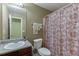 Cozy bathroom featuring granite countertops and a decorative shower curtain for a touch of style at 4089 Palm Dr, Snellville, GA 30039