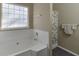 Bright bathroom featuring a shower, tub, and patterned shower curtain at 4089 Palm Dr, Snellville, GA 30039