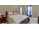 Comfortable bedroom with neutral walls, a cozy bed, and soft natural light from the sheer curtains at 4089 Palm Dr, Snellville, GA 30039
