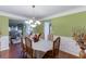 Dining room with elegant chandelier, table set for six, and hardwood floors at 4089 Palm Dr, Snellville, GA 30039