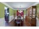 Dining room with elegant chandelier, hardwood floors, and decorative wooden cabinet at 4089 Palm Dr, Snellville, GA 30039