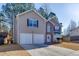 Charming two-story home with a two-car garage and brick entryway and well maintained lawn at 4089 Palm Dr, Snellville, GA 30039