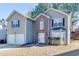 Charming two-story home with a two-car garage and brick entryway and well maintained lawn at 4089 Palm Dr, Snellville, GA 30039