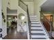 Inviting foyer with staircase, hardwood floors, and elegant decor, leading to dining area at 4089 Palm Dr, Snellville, GA 30039