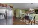 Kitchen and dining area with stainless steel fridge and wood flooring connecting to the living room at 4089 Palm Dr, Snellville, GA 30039