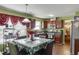 Well-lit kitchen with hardwood floors and stylish cabinetry and a dining table in the center at 4089 Palm Dr, Snellville, GA 30039