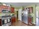 Kitchen with stainless steel appliances, granite counters, hardwood floors, and dark wood cabinets at 4089 Palm Dr, Snellville, GA 30039