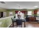 Bright kitchen featuring modern appliances, dining table and wood flooring, next to a living space at 4089 Palm Dr, Snellville, GA 30039