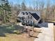 Aerial view of a brick home with a long driveway and a spacious yard surrounded by trees at 4111 Alayna Lee Cir, Mcdonough, GA 30252