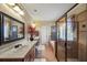 Tastefully designed bathroom offers a shower, soaking tub, a double sink vanity, and warm lighting at 4111 Alayna Lee Cir, Mcdonough, GA 30252