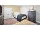 Bedroom featuring a closet, bed, dresser and carpeted floors at 4111 Alayna Lee Cir, Mcdonough, GA 30252