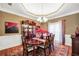 Formal dining room featuring a chandelier, elegant furniture, and plenty of natural light at 4111 Alayna Lee Cir, Mcdonough, GA 30252