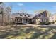 Beautiful brick home with dormer windows, a covered porch, and lush landscaping at 4111 Alayna Lee Cir, Mcdonough, GA 30252