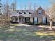 Charming brick home featuring a well-manicured lawn, covered porch, and inviting curb appeal at 4111 Alayna Lee Cir, Mcdonough, GA 30252
