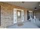 Inviting front porch with brick facade, rocking chairs, and a 'Welcome' mat at 4111 Alayna Lee Cir, Mcdonough, GA 30252