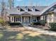 Inviting front porch with decorative columns and a walkway leading to the front door and rocking chairs at 4111 Alayna Lee Cir, Mcdonough, GA 30252