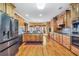 Well-lit kitchen featuring wood cabinets, stainless steel appliances, granite counters and hardwood floors at 4111 Alayna Lee Cir, Mcdonough, GA 30252