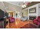 Elegant living room with a fireplace, hardwood floors, and seamless transition to the dining area at 4111 Alayna Lee Cir, Mcdonough, GA 30252