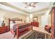 Well-lit main bedroom showcases a bed with wrought iron accents, light walls, and a dark-patterned rug at 4111 Alayna Lee Cir, Mcdonough, GA 30252