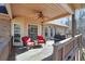 Covered porch area with seating, a ceiling fan, and a grill; brick and siding exterior at 4111 Alayna Lee Cir, Mcdonough, GA 30252