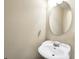 Powder room with a pedestal sink and decorative round mirror at 4111 Alayna Lee Cir, Mcdonough, GA 30252