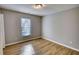 Bedroom featuring wood flooring, neutral walls, and natural light from a window at 61 Andrew Rd, Covington, GA 30016