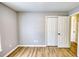 Bright bedroom showcasing hardwood floors, an off-white closet, and neutral walls at 61 Andrew Rd, Covington, GA 30016