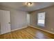 Bedroom with hardwood floors, a window, and standard closet at 61 Andrew Rd, Covington, GA 30016