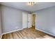 Sunlit bedroom featuring hardwood floors, neutral walls, a closet and bright light fixture at 61 Andrew Rd, Covington, GA 30016