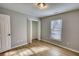 Bright bedroom featuring hardwood floors, neutral walls, window and closet with an open door at 61 Andrew Rd, Covington, GA 30016