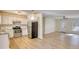 Open kitchen and dining area with stainless steel appliances and wood-look floors at 61 Andrew Rd, Covington, GA 30016