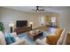Bright living room with wood floors, modern furniture, and an open dining area at 61 Andrew Rd, Covington, GA 30016