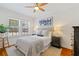 Cozy bedroom featuring hardwood floors, a ceiling fan, and two windows for ample natural light at 794 Frederica Ne St # 2, Atlanta, GA 30306