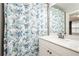 Bathroom with a floral shower curtain and a white vanity at 1323 Faircrest Way, Suwanee, GA 30024