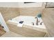 Soaking tub with ceramic tile surround and bronze fixtures at 1323 Faircrest Way, Suwanee, GA 30024