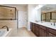 Modern bathroom with a walk-in shower, soaking tub, and double sink vanity at 1323 Faircrest Way, Suwanee, GA 30024